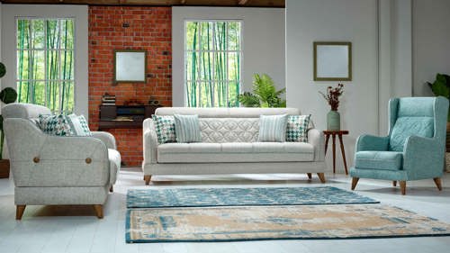 a living room with curved furniture and two blue rugs on the floor.